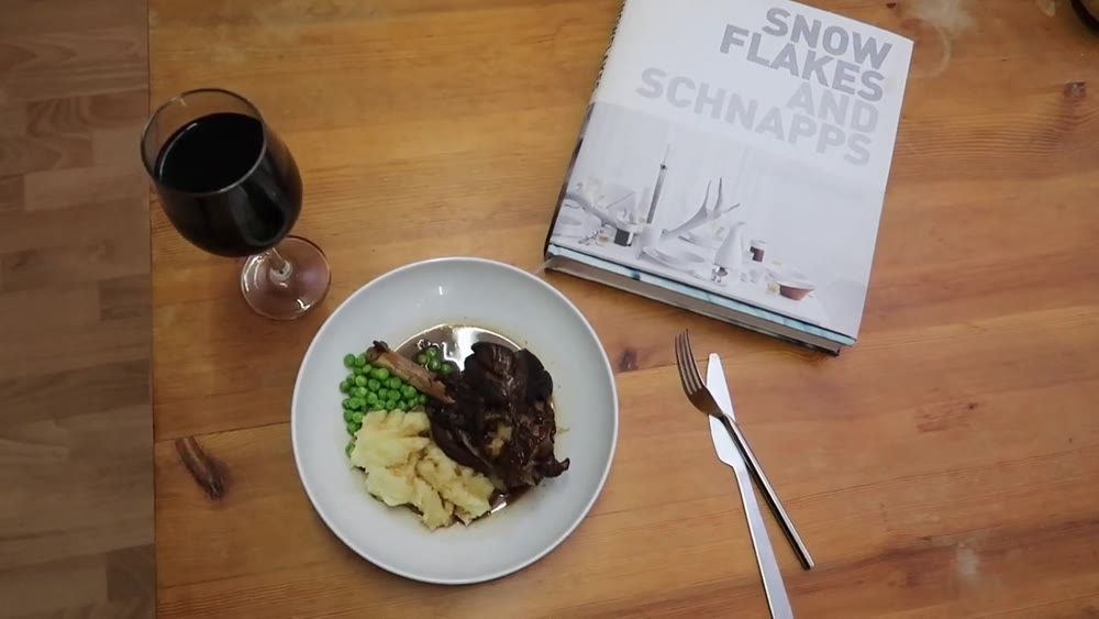 Braised lamb shanks served with mashed potatoes, peas and red-wine sauce