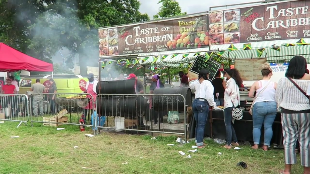 Taste of the Caribbean food stall with barbecues and waiting customers