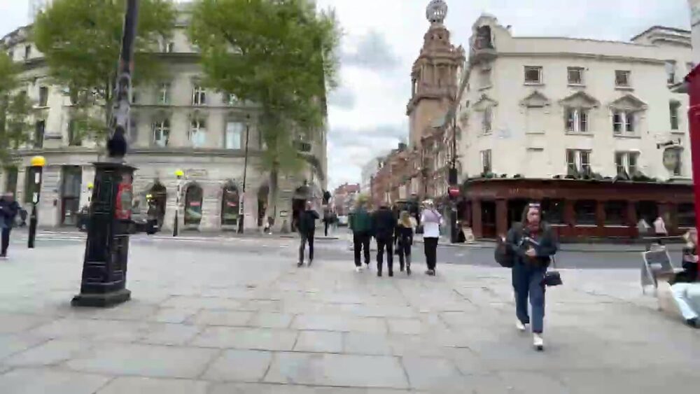 Pedestrians crossing Leicester Square in central London