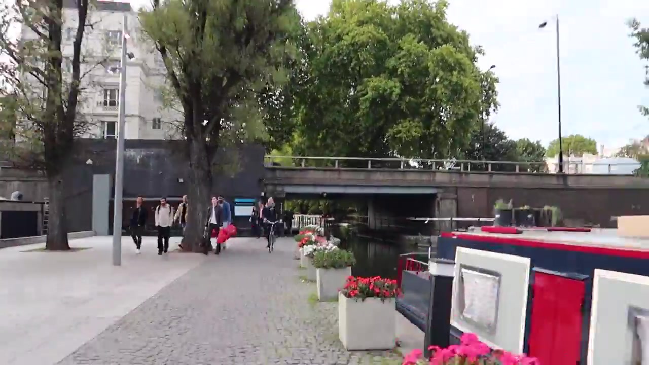 Moored narrowboats and the tree-lined towpath on the approach to Little Venice.