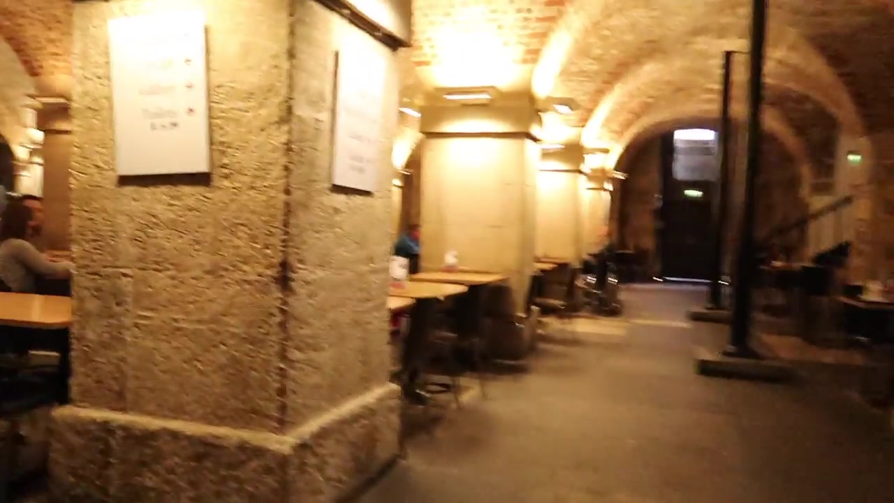 Brick arches and dining tables inside the Café in the Crypt