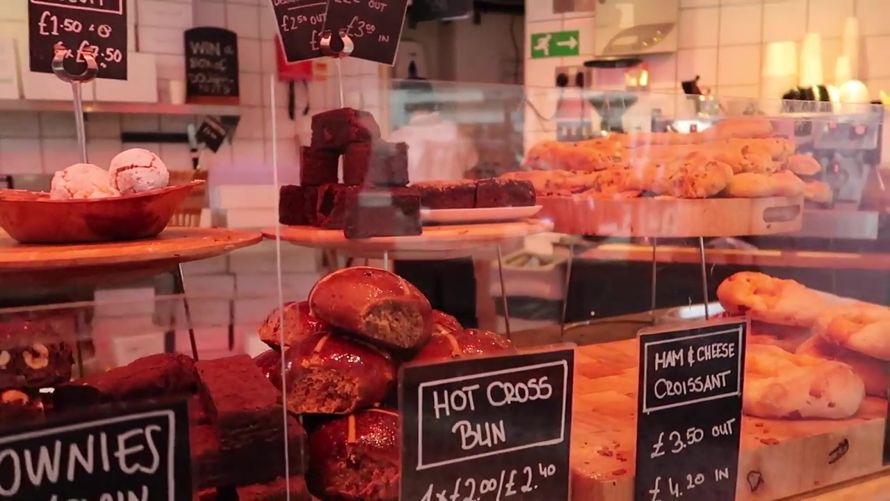 Hot cross bun doughnuts displayed inside Bread Ahead bakery