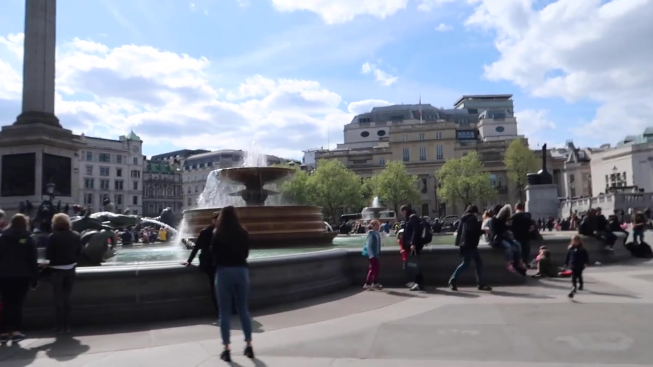 Trafalgar Square with fountains, Nelson's Column and spring visitors
