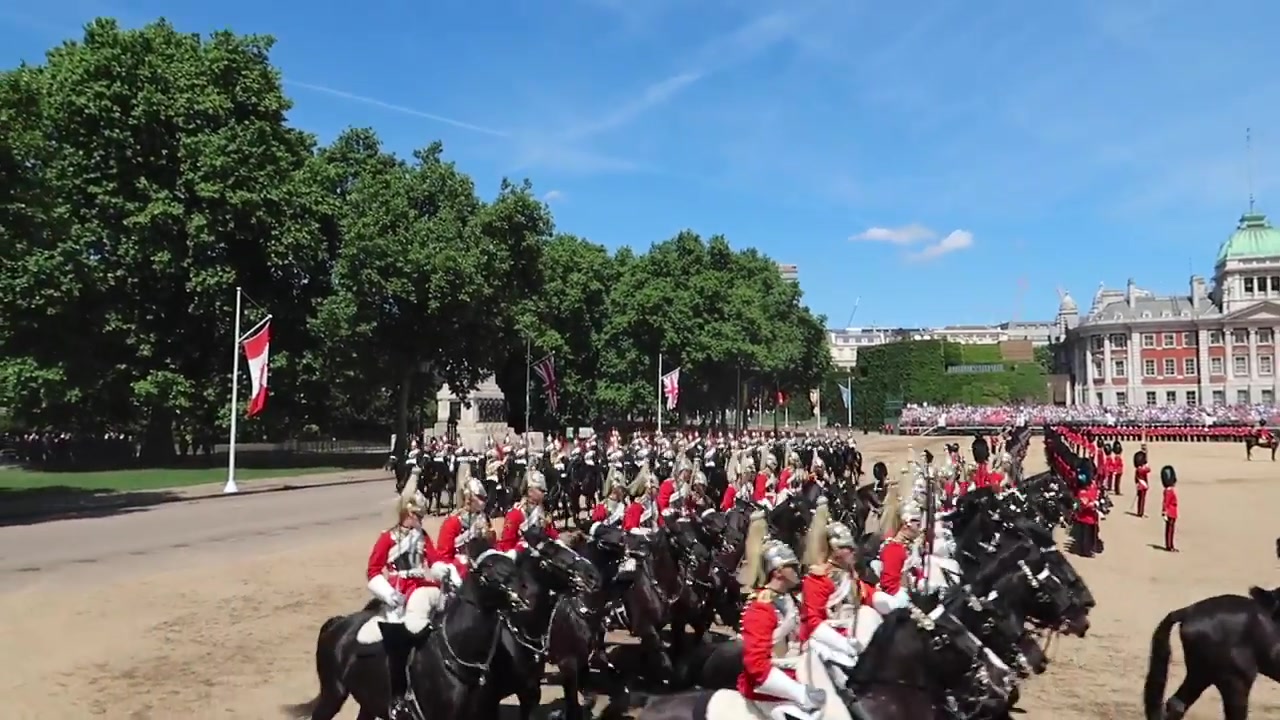 Mounted cavalry passing the spectator stands at Horse Guards Parade