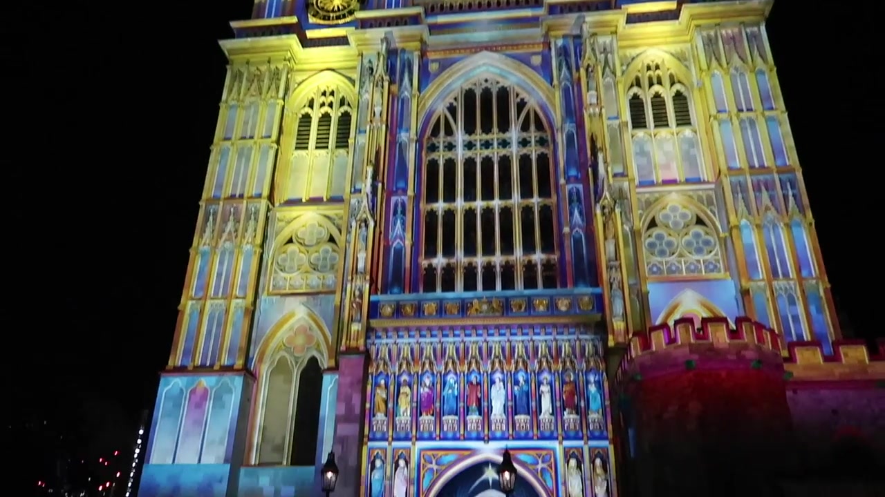 Colourful projections across the abbey façade during Lumiere London.