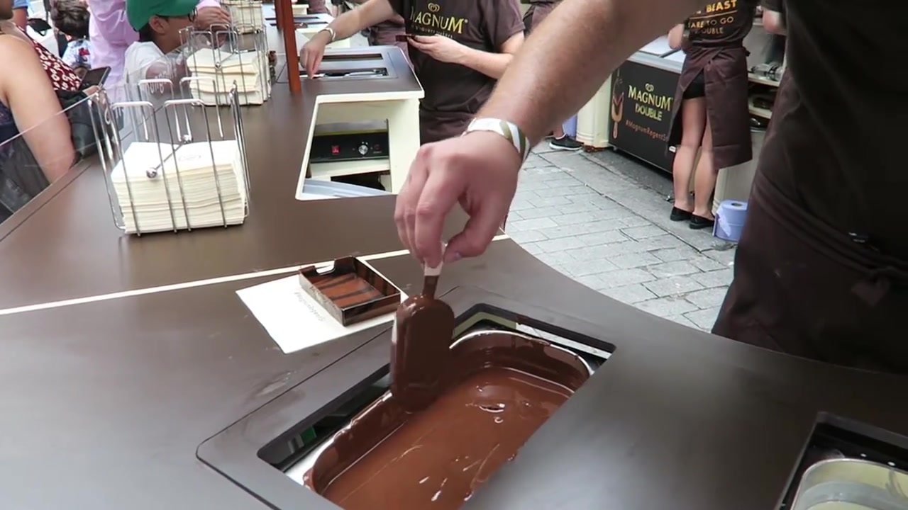 Vanilla Magnum lifted from melted dark chocolate at the counter