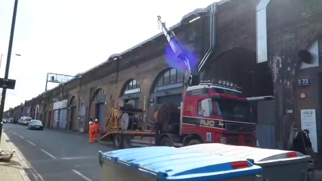 Brick railway arches and vehicles along Druid Street