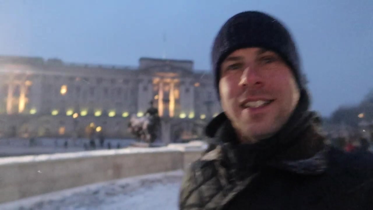 Barry outside Buckingham Palace during the snowy March evening.
