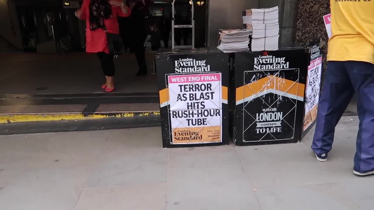 Evening Standard newspaper board beside the entrance to Monument station