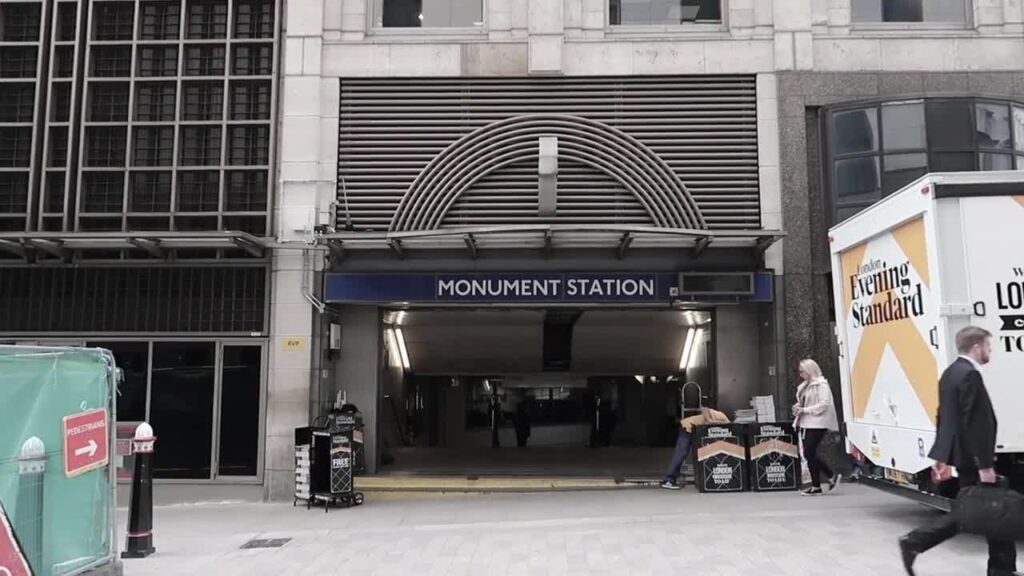 People walking past the Monument Underground station entrance in September 2017