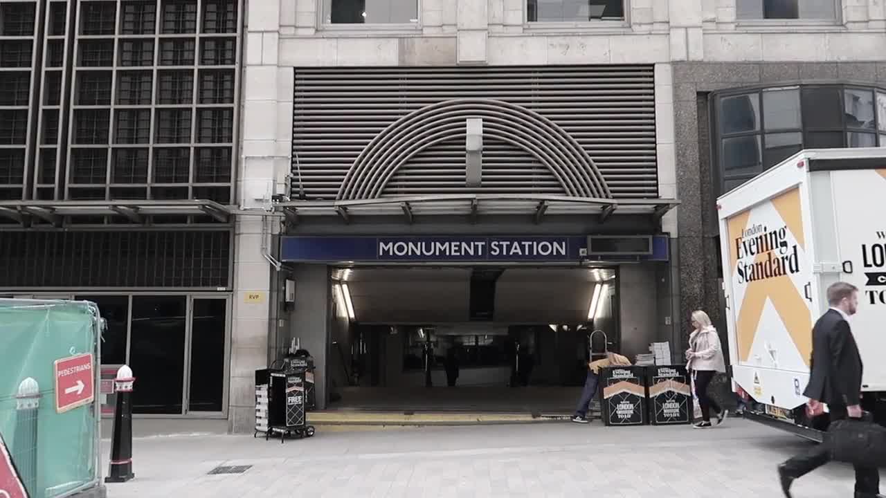 People walking past the Monument Underground station entrance in September 2017