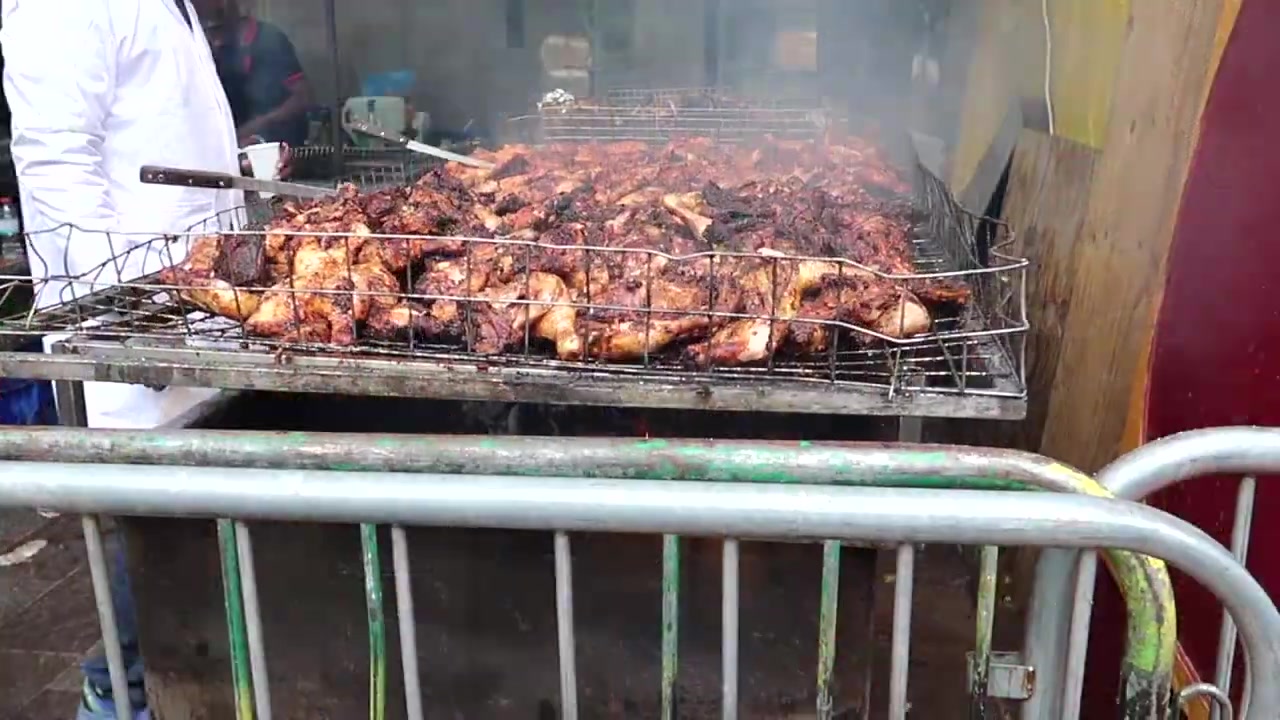 Chicken cooking on a barbecue beside the Notting Hill Carnival route