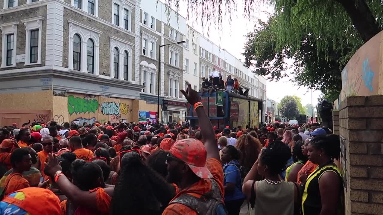 Carnival crowd gathered in the street during the Grenfell remembrance sequence
