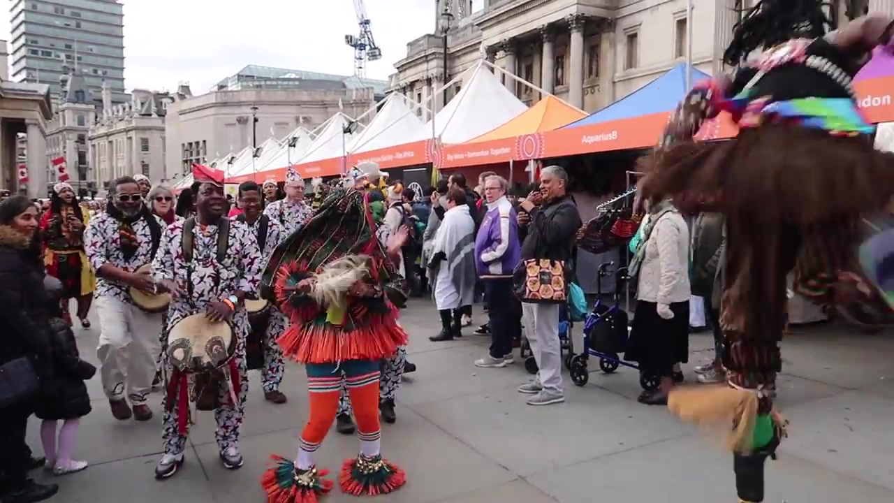Costumed performers bring colour and movement to Trafalgar Square.