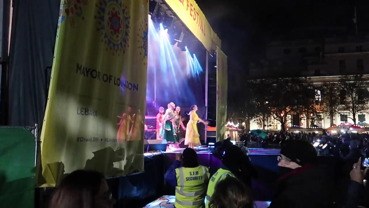 Watching a Diwali performance from the side of the stage.
