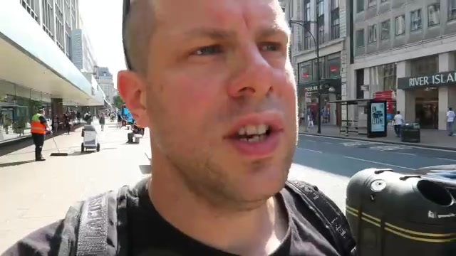 Barry Roberts walking along Oxford Street beside its shops