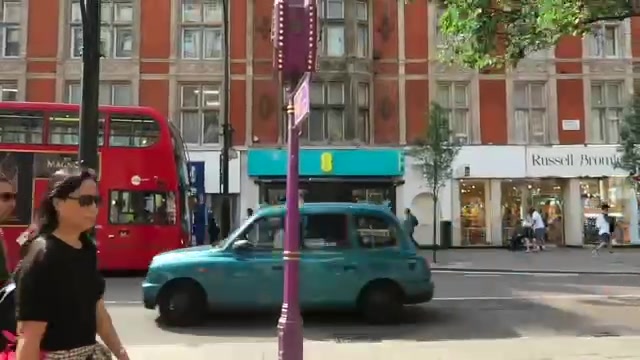 Red bus and turquoise taxi seen from St Christopher’s Place