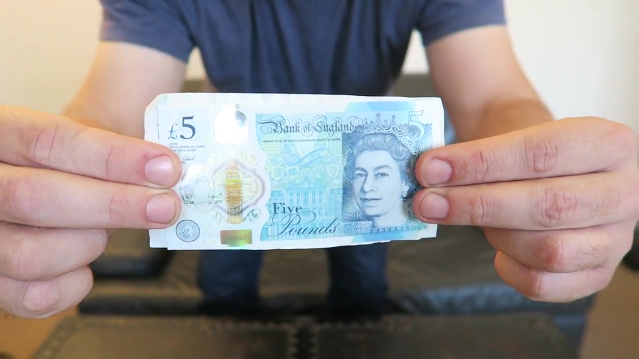Barry compares the larger paper five-pound note with the smaller polymer fiver