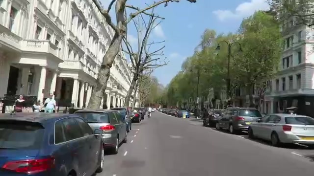 Sunny Kensington street with white terraces during the cycle ride