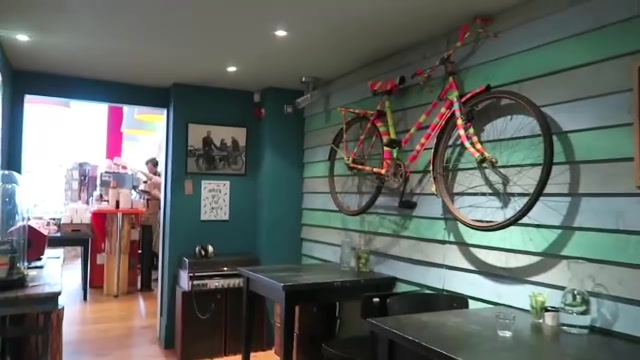 Bicycle displayed on the wall inside Pedlars cafe and shop