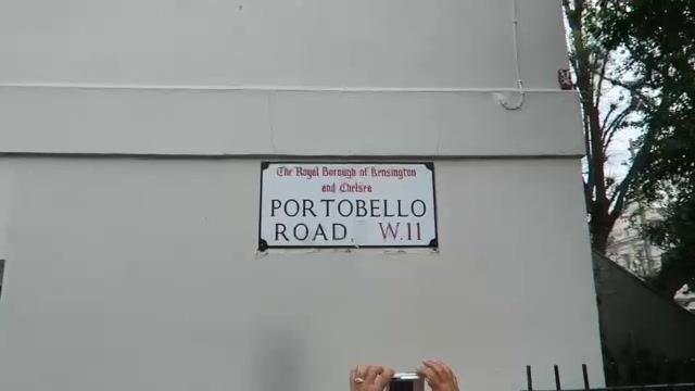 Portobello Road W11 street sign on a pale wall