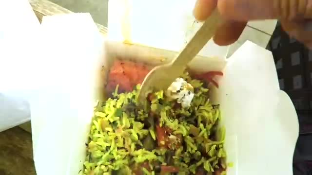 Takeaway box of salad with a wooden fork