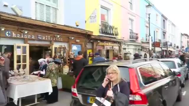 Visitors and antiques shops on a busy Portobello Road