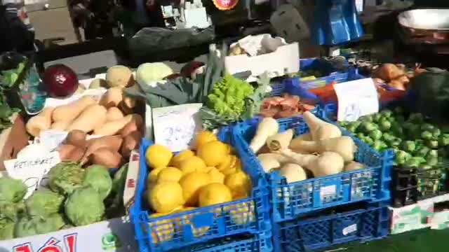 Fruit and vegetables stacked in crates at a market stall