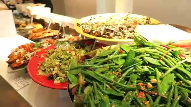 Colourful prepared salads displayed on large platters