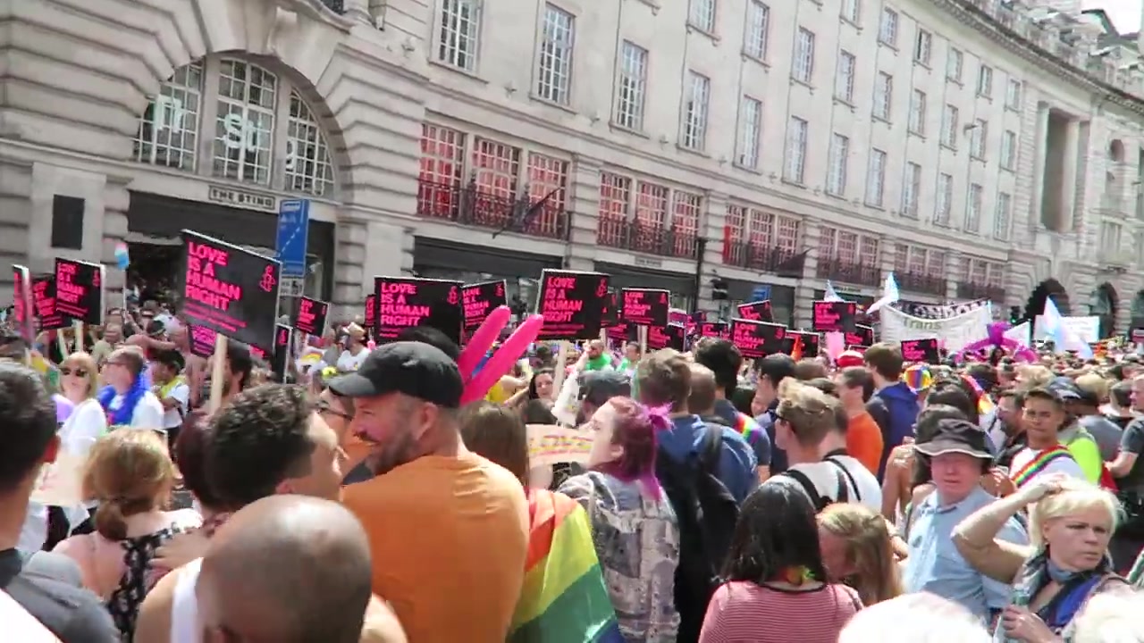 Marchers carrying Love Is a Human Right placards on Regent Street