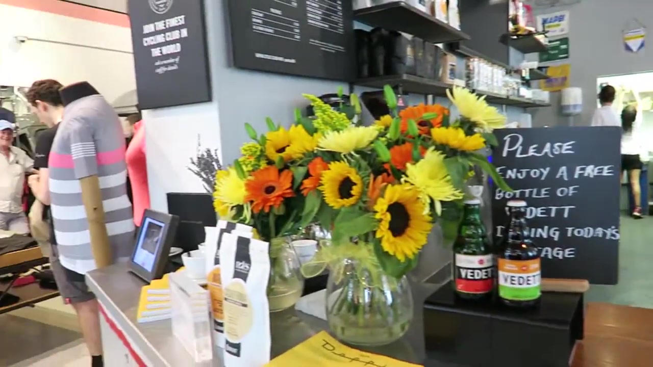 Sunflowers, cups and a coffee counter at the Rapha café