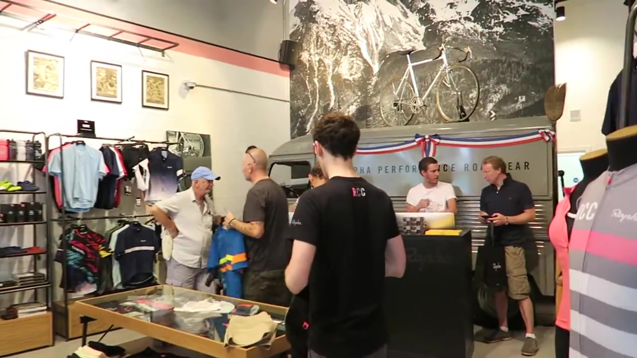 Rapha London café counter with cycling artwork and customers in 2016