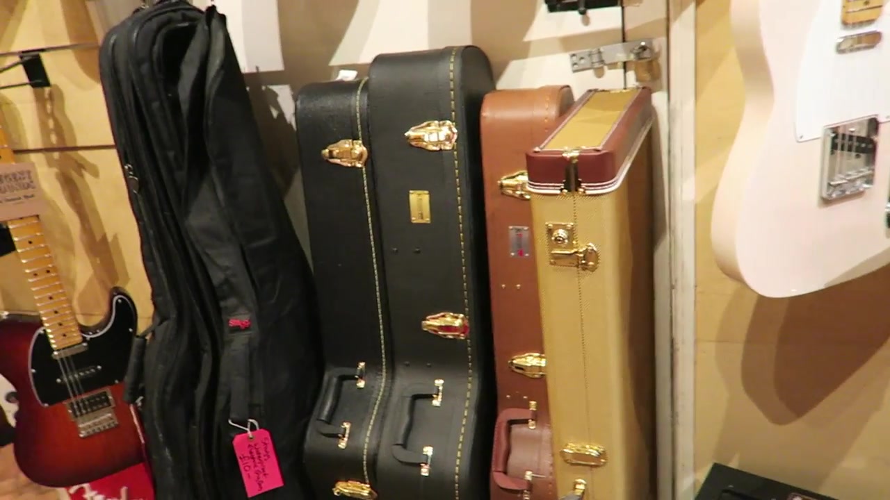 Guitar cases and instruments on display inside Regent Sounds