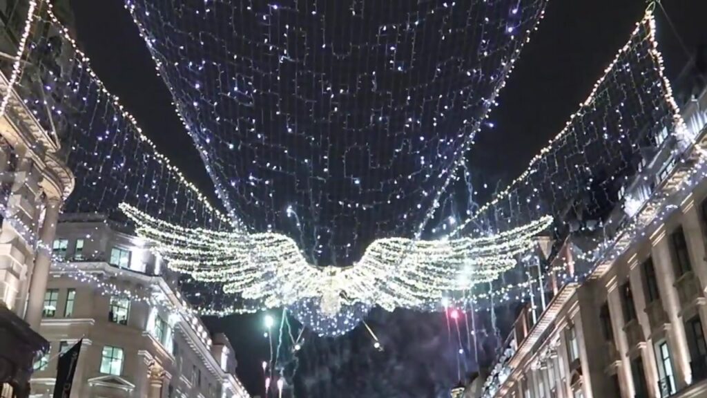An illuminated angel stretches across Regent Street beneath a canopy of lights.