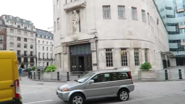BBC Broadcasting House exterior with passing London traffic