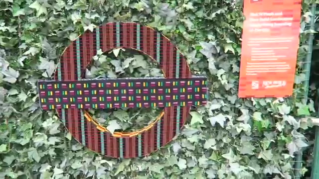 Colourful transport roundel displayed against green foliage