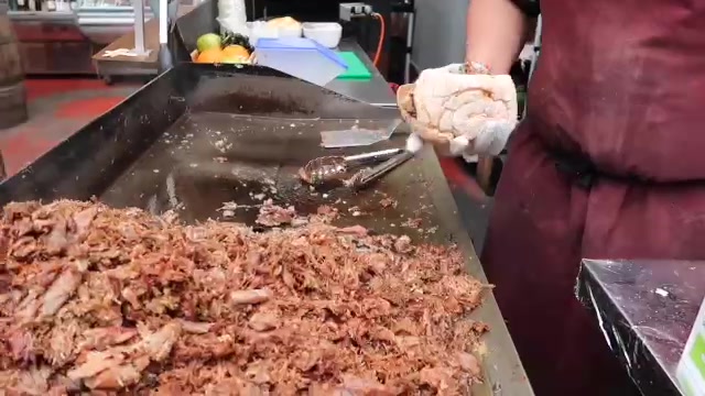 A duck confit sandwich being filled at a Borough Market stall