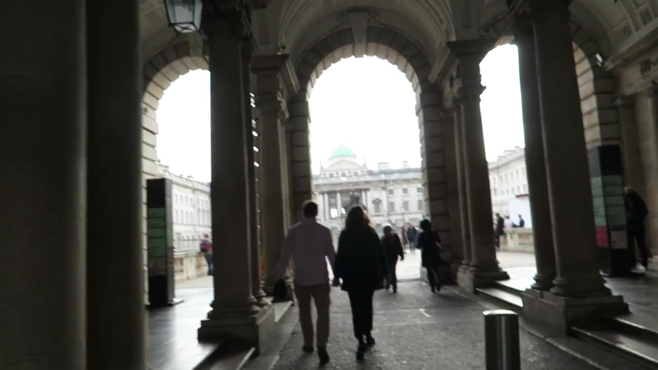 Visitors walking through the arched entrance towards the Somerset House courtyard
