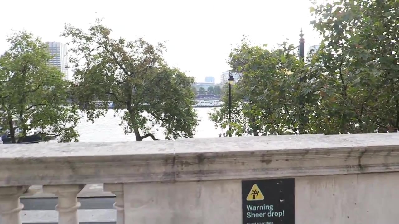 Stone terrace balustrade with trees and the Thames beyond at Somerset House