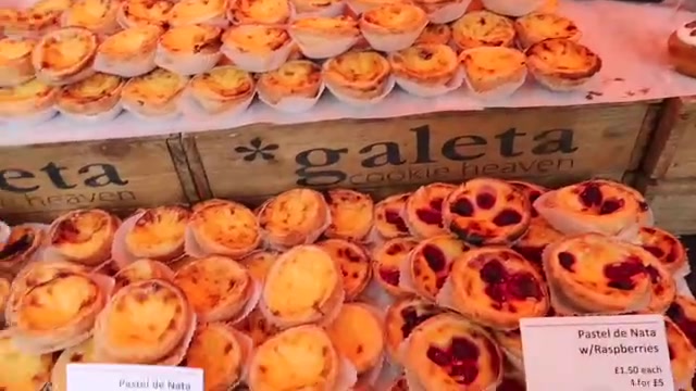 Portuguese custard tarts arranged on the market stall counter
