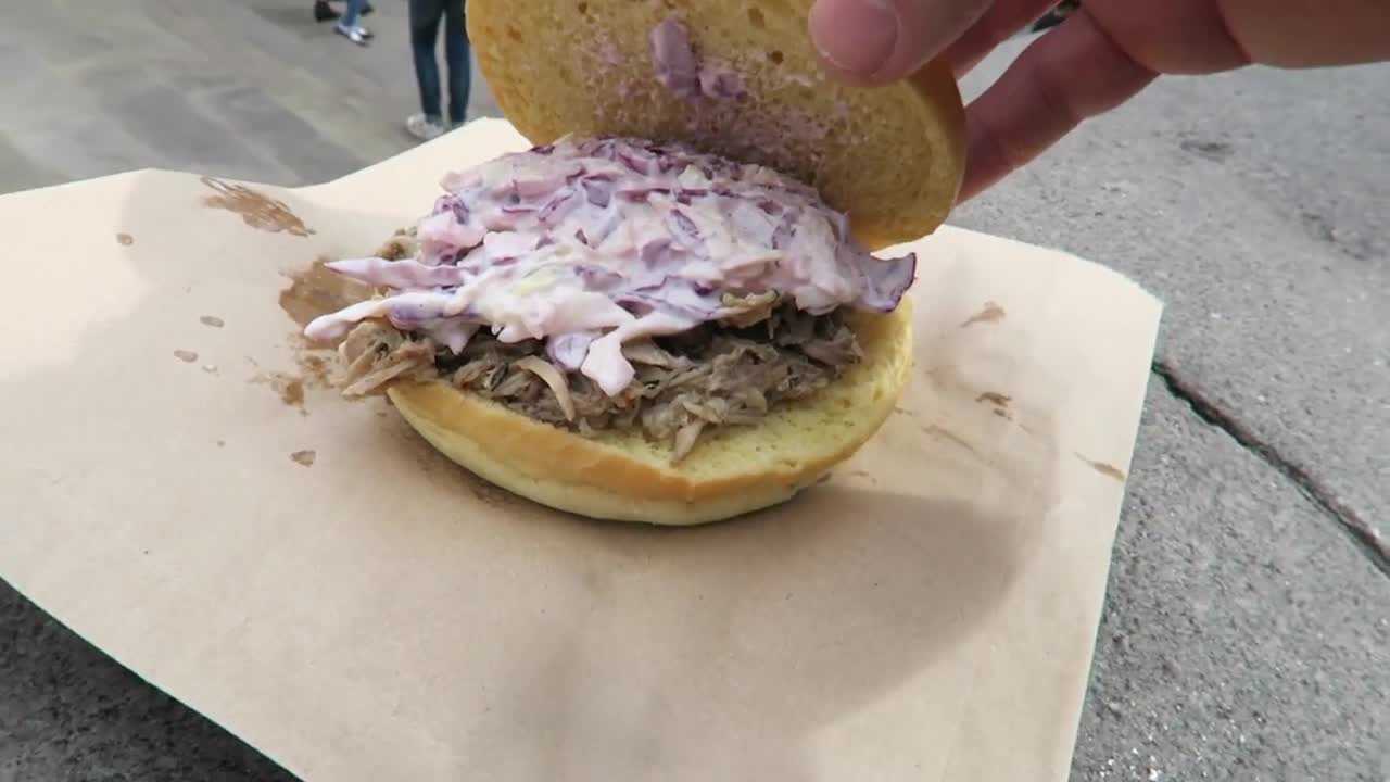 Pulled pork bun opened to show the meat and slaw