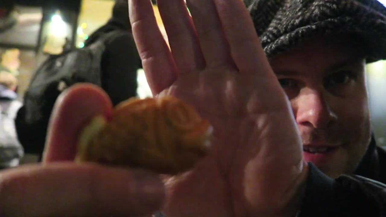 Barry holding a golden fish-shaped taiyaki cake outside Chinatown Bakery