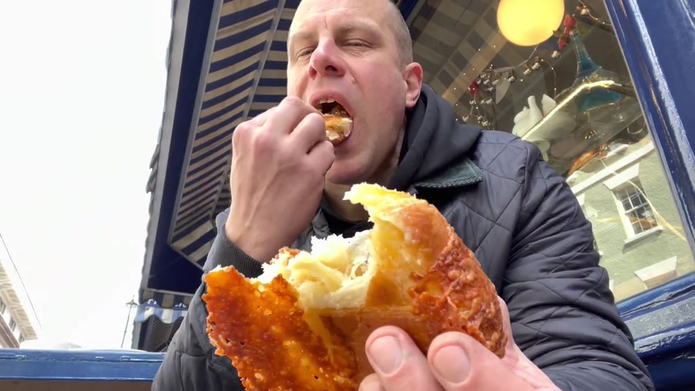 Tasting a French pastry outside Maison Bertaux in Greek Street