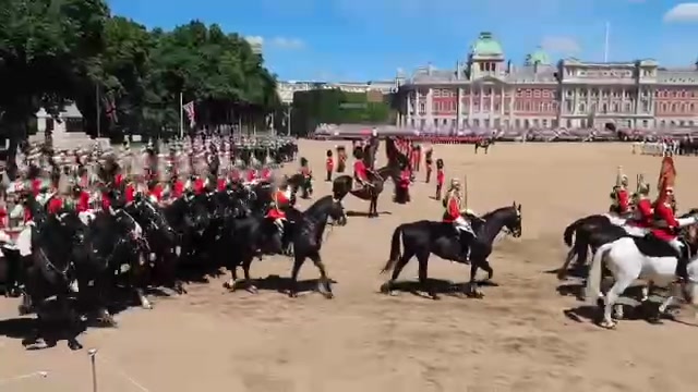 Mounted cavalry riding past the stands at Horse Guards Parade