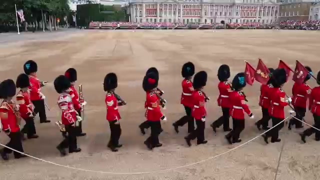 Foot Guards marching in red tunics and bearskins at Horse Guards Parade