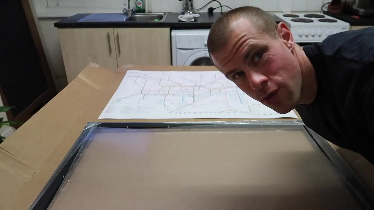 The Tube map poster and an empty black A1 frame on a table