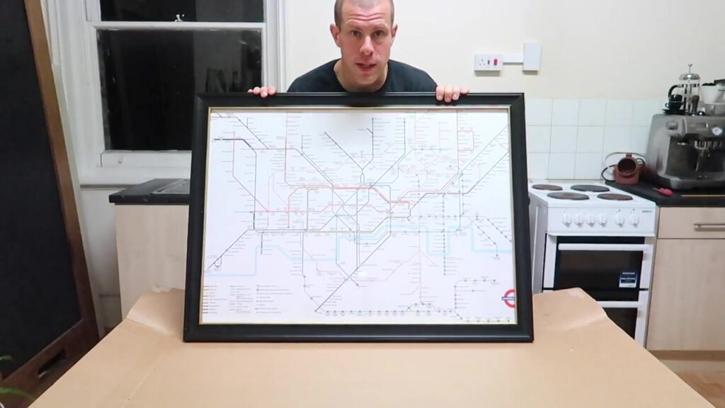 Barry holding the finished Tube map in a black frame