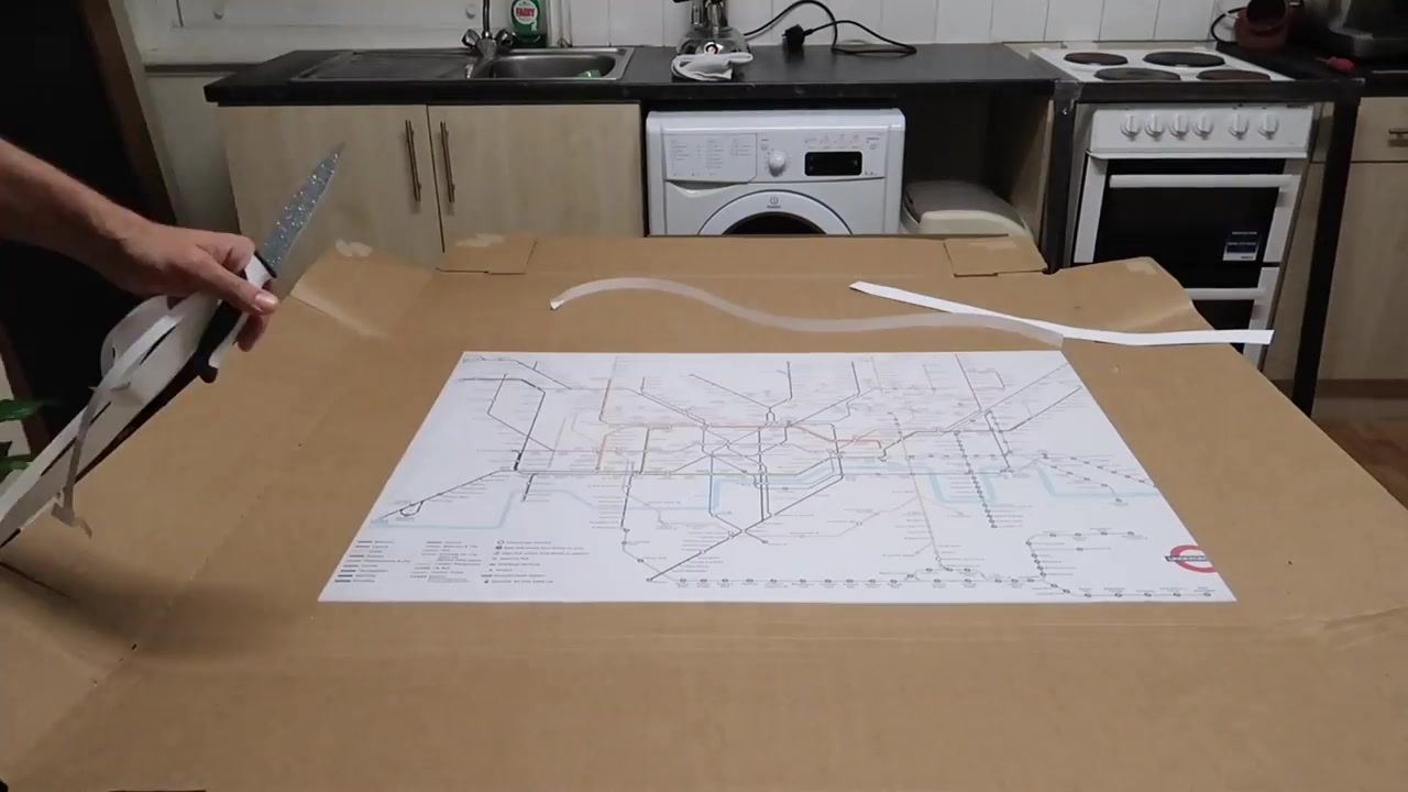 The trimmed Tube map laid on the table beside its offcuts