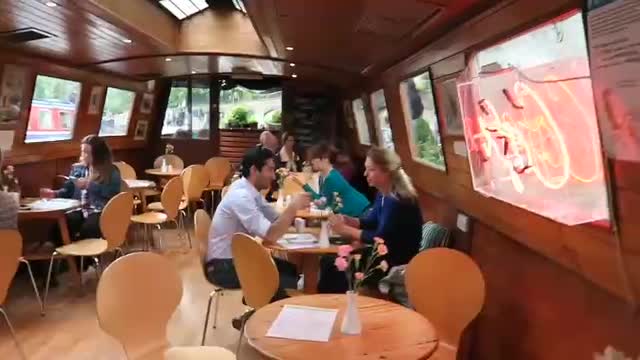 Tables and chairs inside the Waterside Cafe canal boat