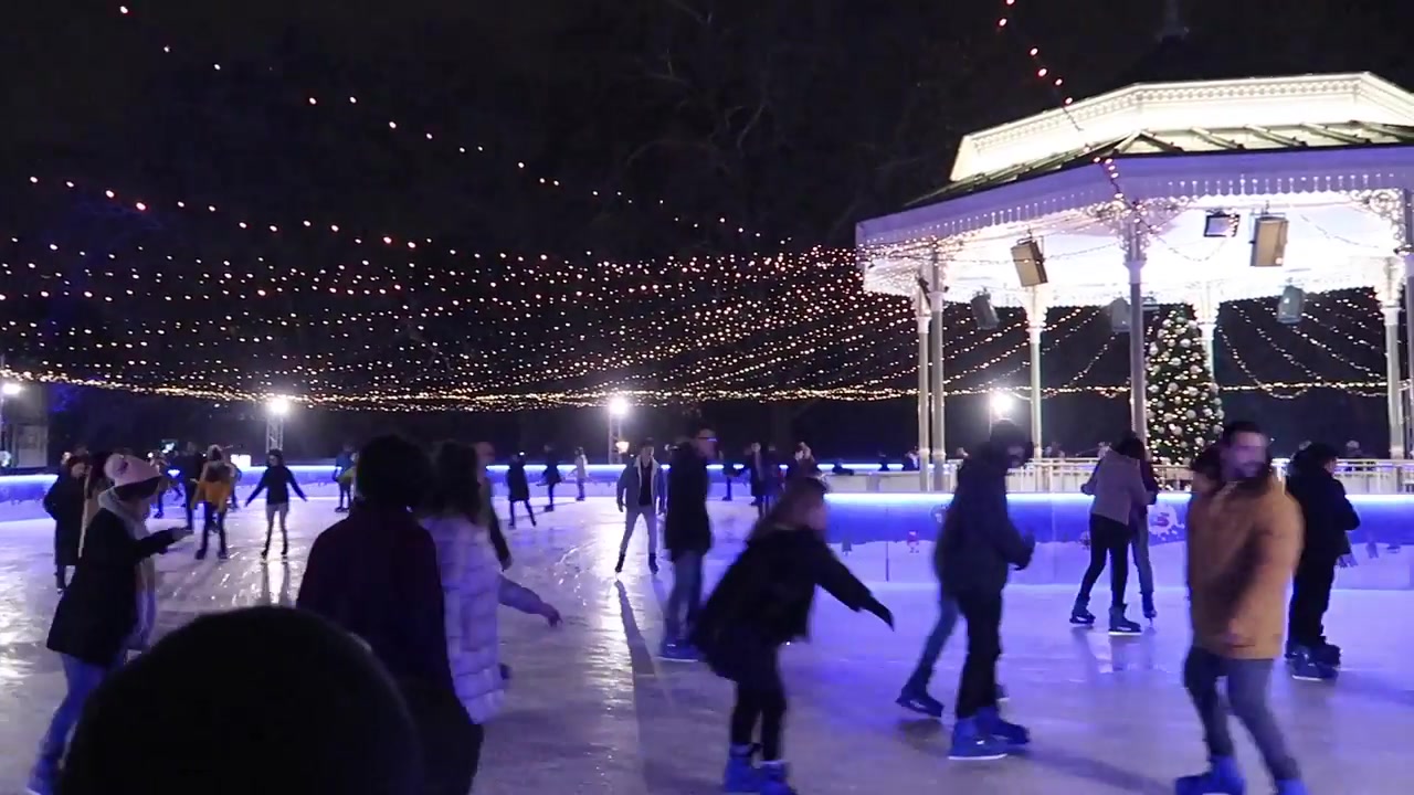 Skaters beneath strings of lights on the Winter Wonderland ice rink